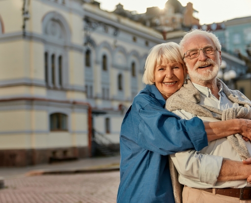 elderly couple hugging and laughing