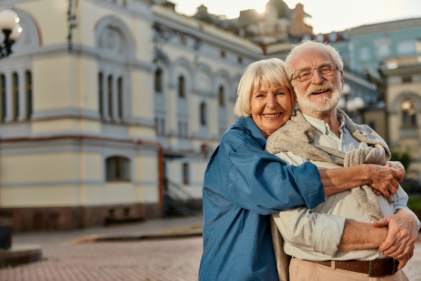 elderly couple hugging and laughing